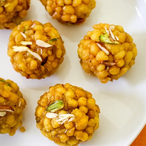 Close up shot of boondi ladoo garnished with chopped nuts