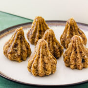 6 dry fruits modak arranged on a plate