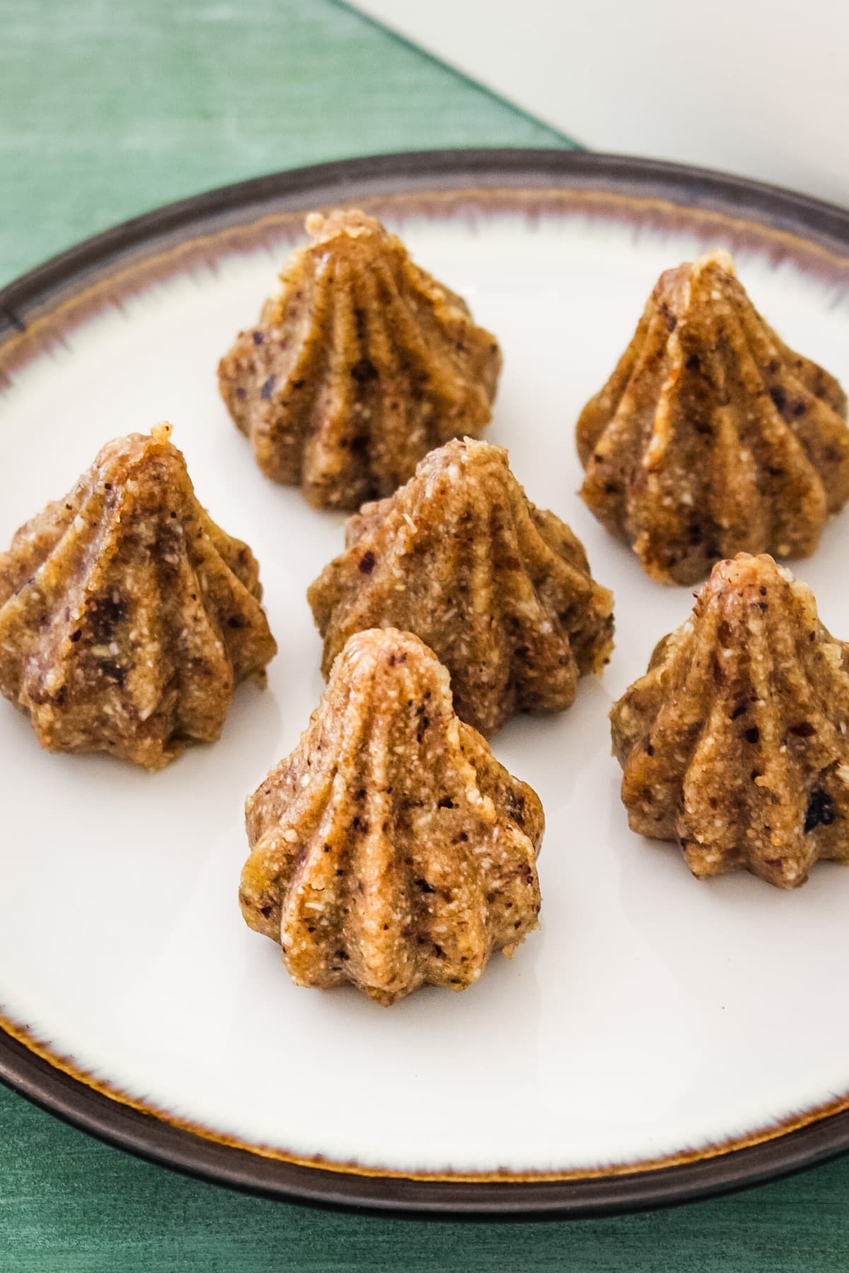 Close up image of dry fruits modak arranged on a plate