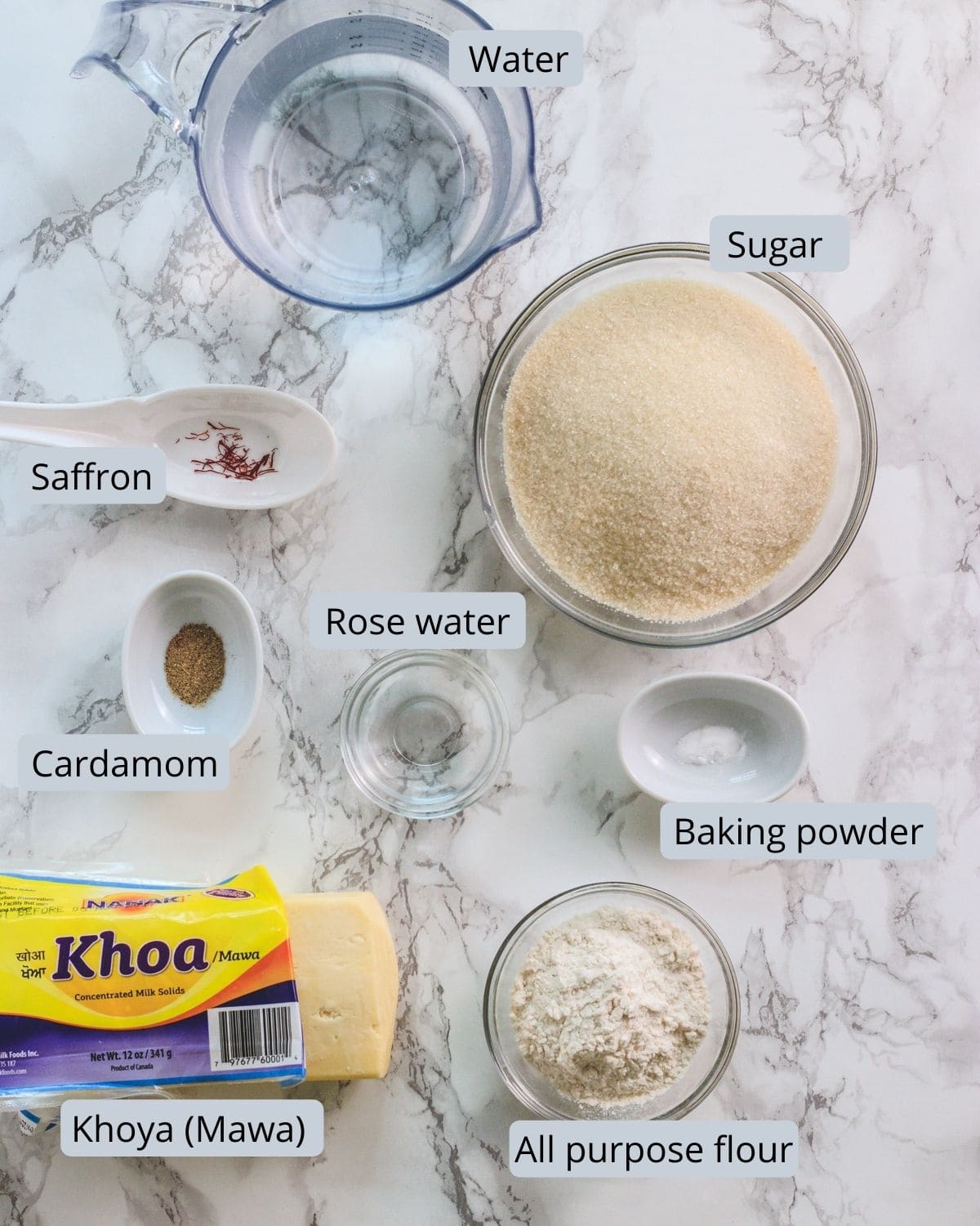 Ingredients used in gulab jamun, includes sugar, water, cardamom, saffron, khoya, flour, baking powder, rose water