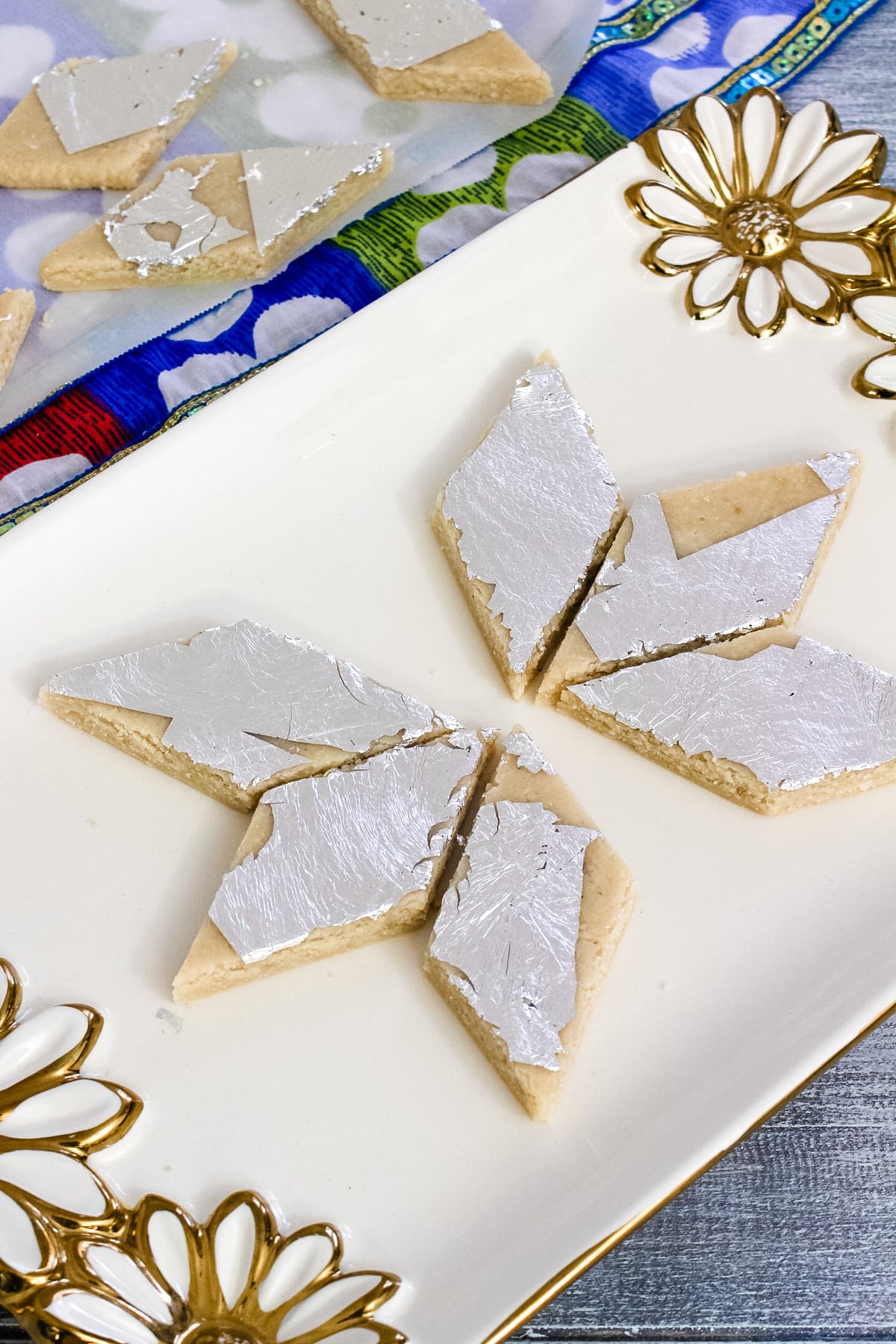 6 kaju katli pieces arranged on a plate.