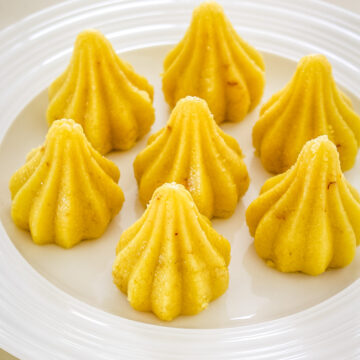 7 modak peda arranged on a white plate