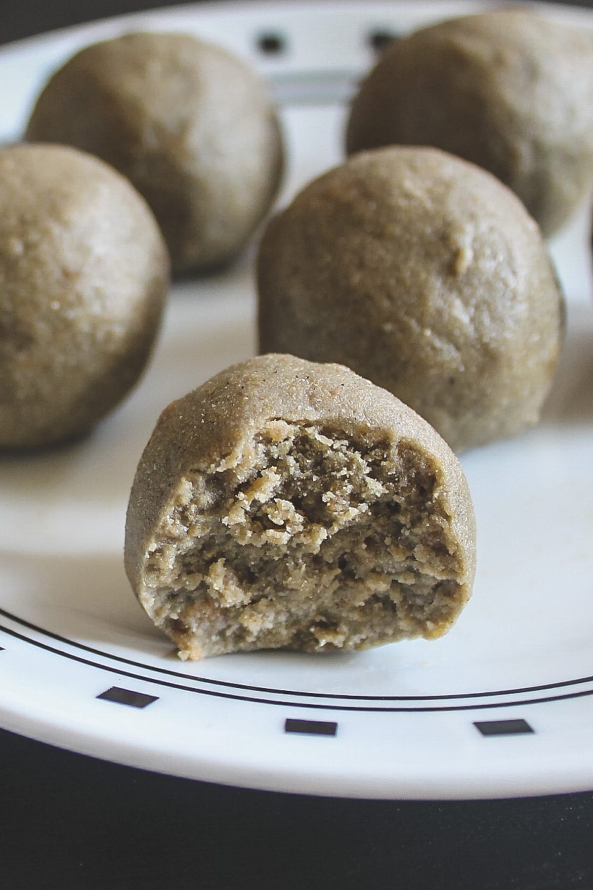 Close up image of kuler ladoo with one bite taken