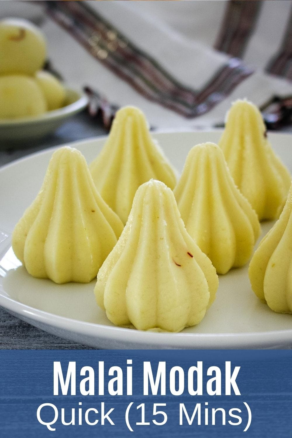 Malai modak on a plate with text at the bottom for pinterest