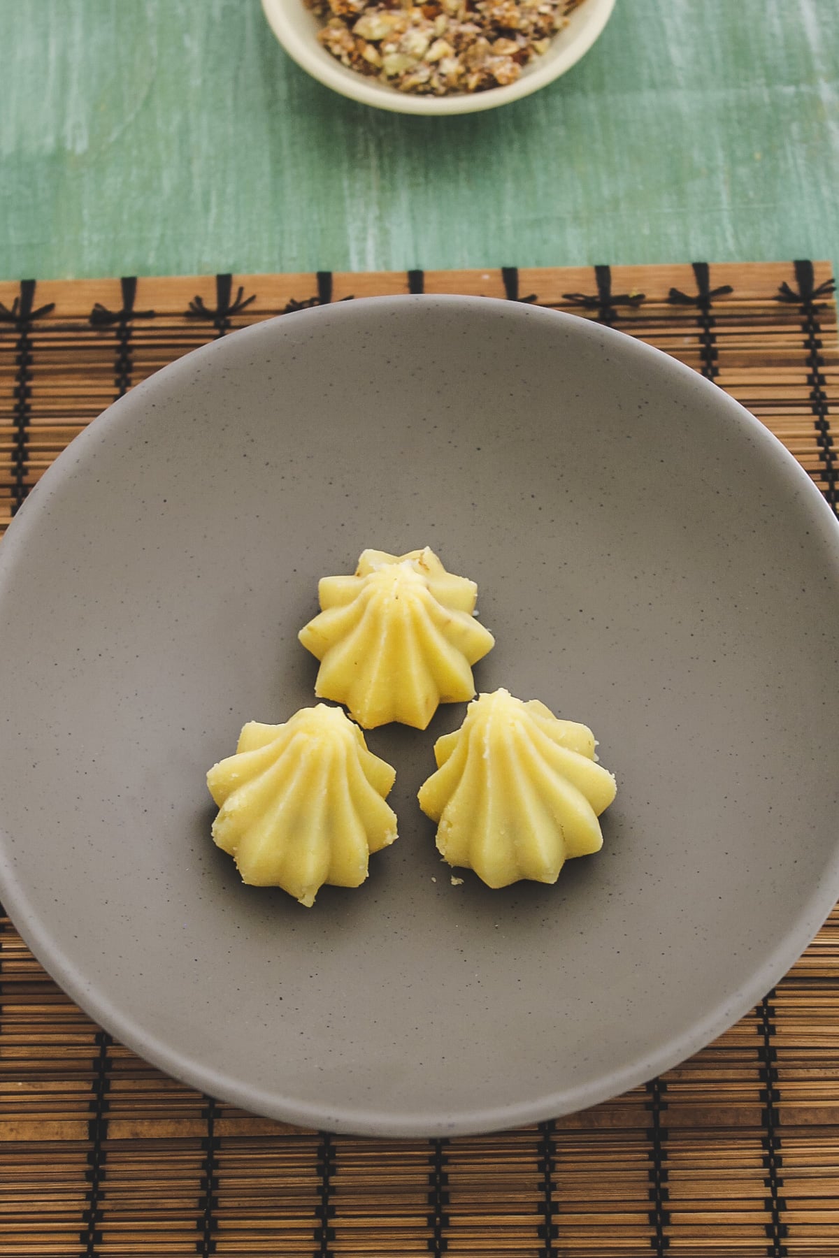 top view of three khoya modak in a deep plate