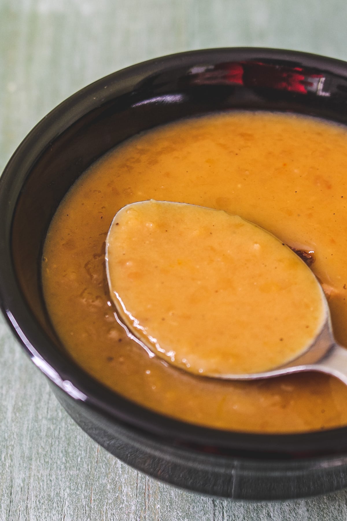 Moong dal kheer taken from a bowl using a spoon ready to eat