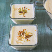 phirni in individual serving bowl garnish with sliced nuts and saffron.