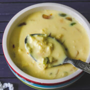 rabri in a bowl and spoonful of it taken, ready to eat