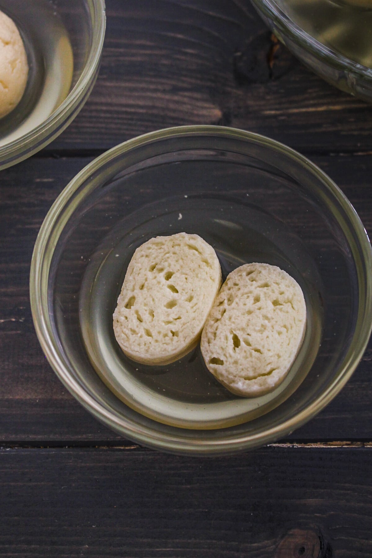 Cut Rasgulla in half with sugar syrup in a bowl