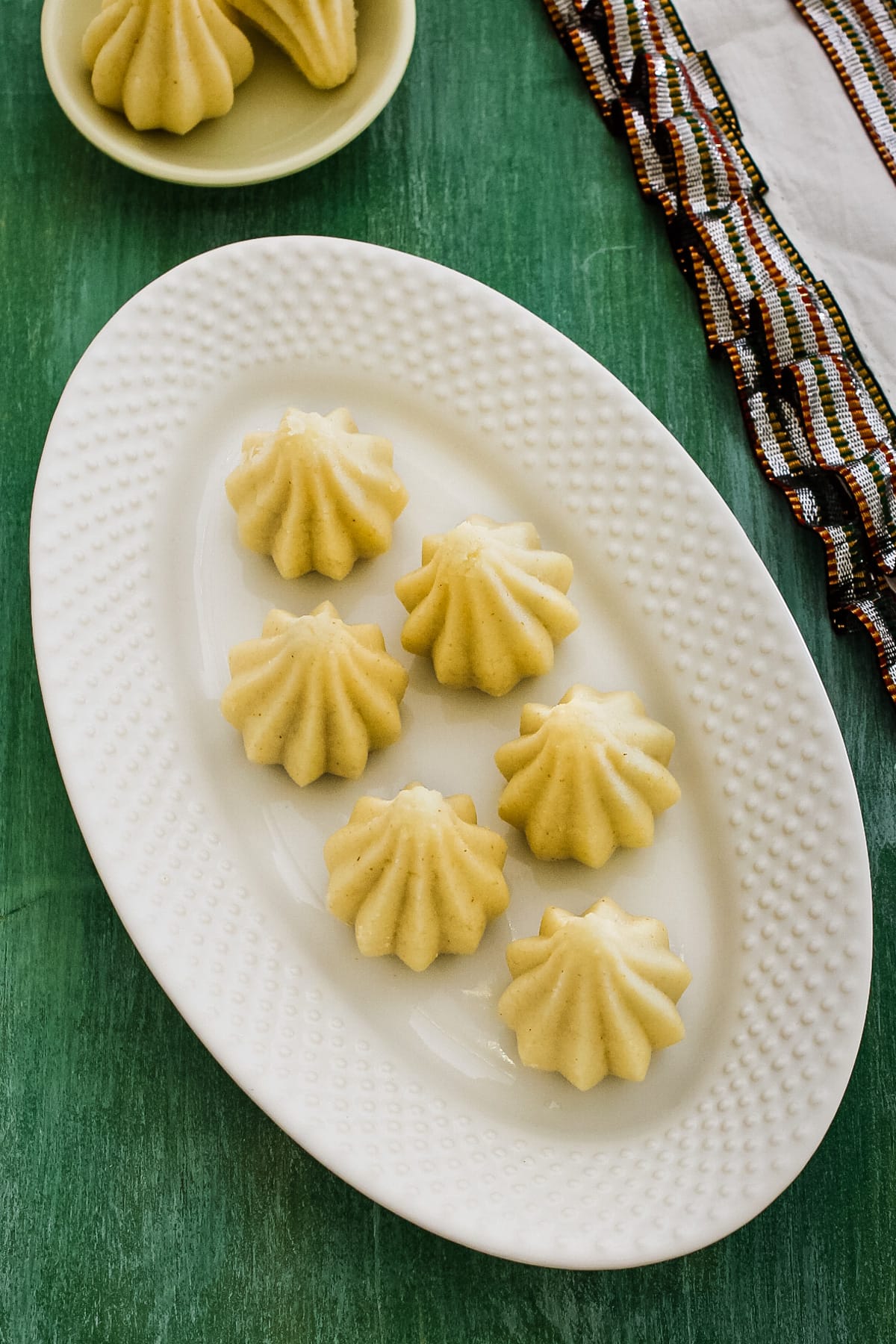 Top view of rava modak arranged on a oval plate