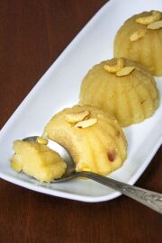 3 scoops of sheera on a plate with one spoonful taken ready to eat.