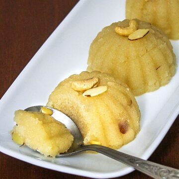 3 scoops of sheera on a plate with one spoonful taken ready to eat.