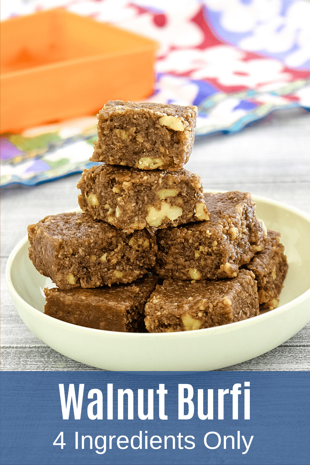 stack of walnut barfi in a plate with text at the bottom of the image