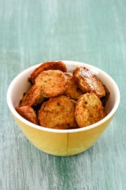 sukhi arbi fry served in a small yellow bowl