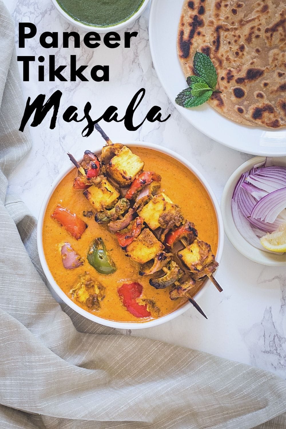 paneer tikka masala in a bowl with text on the image for pinterest