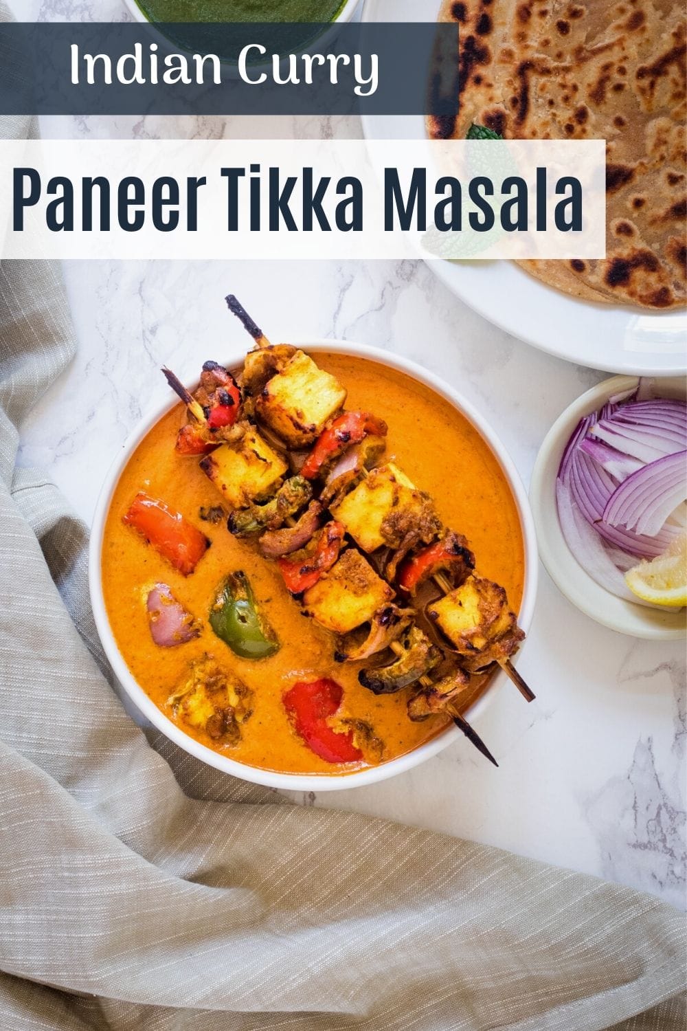 top view of paneer tikka masala with text on the image for pinterest