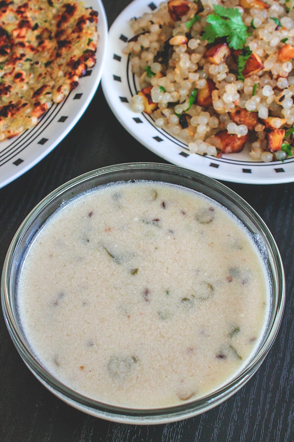 Rajgira kadhi in a bowl served with sabudana kadhi and thalipeeth on side.