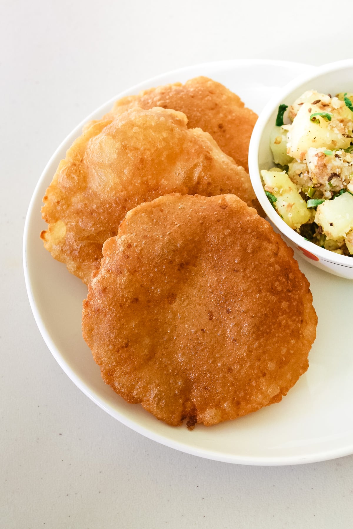 Rajgira puri in a plate with side of sukhi bhaji