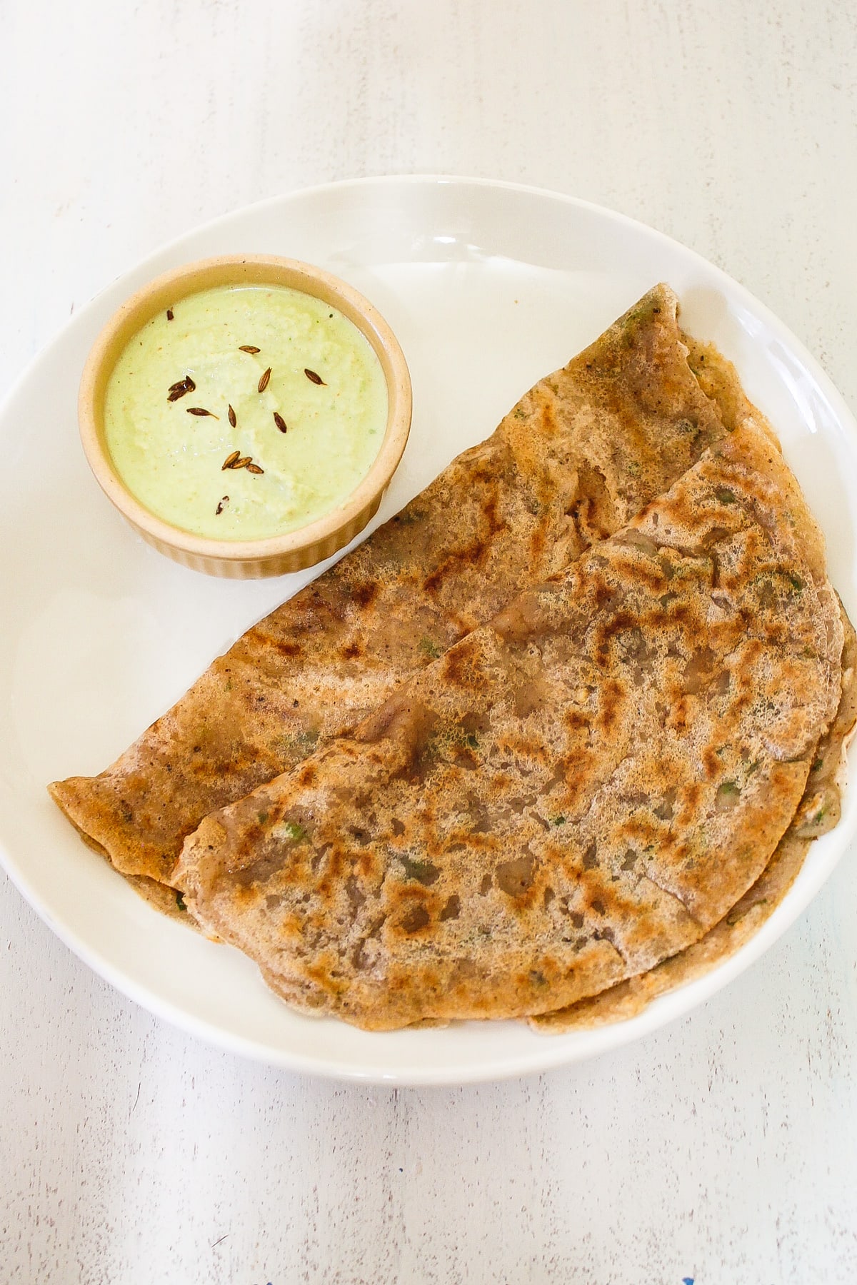 farali dosa in a plate served with coconut chutney