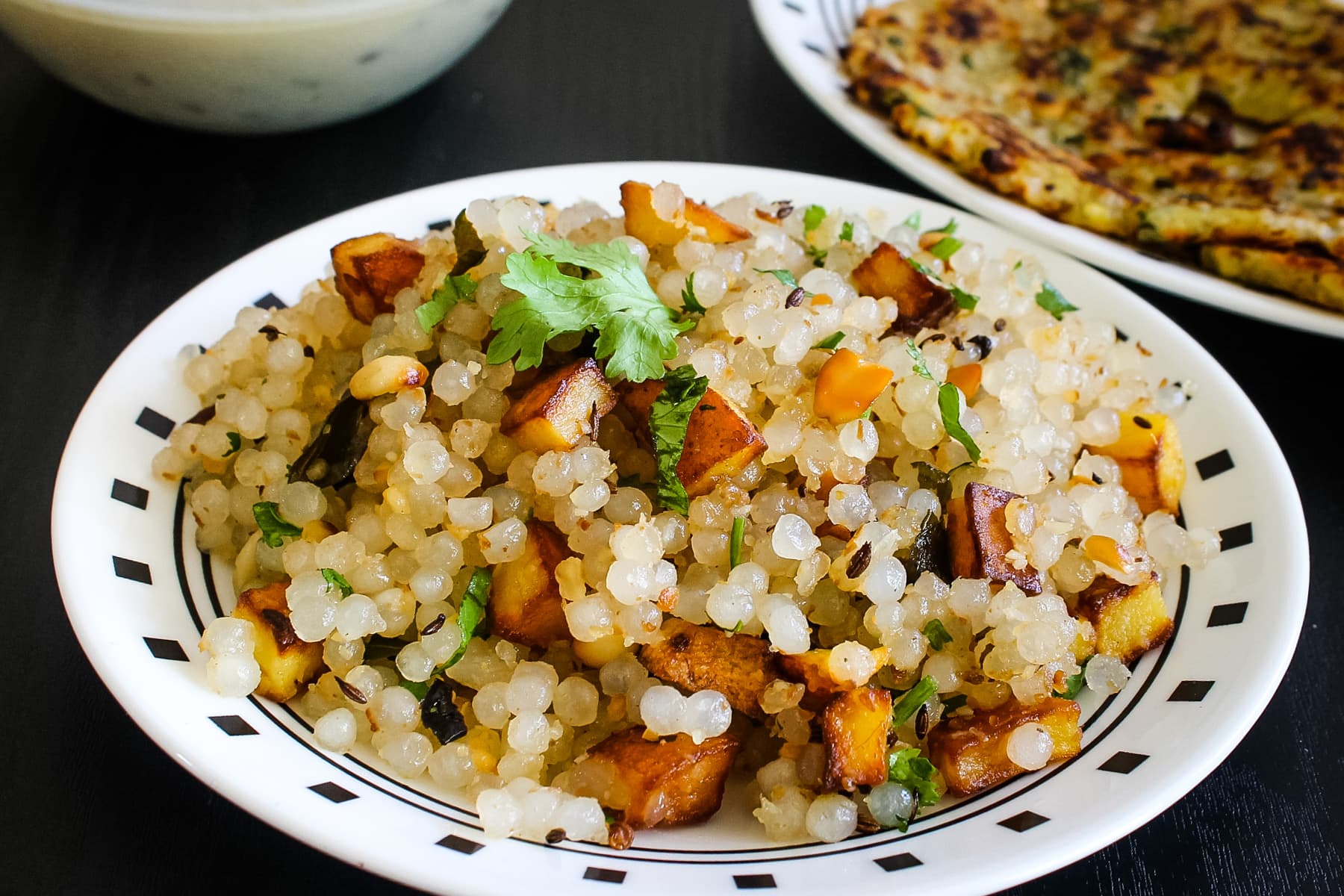 Sabudana khichdi in a plate with a garnish of cilantro