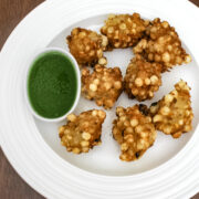 sabudana pakoda on a plate with side of green chutney