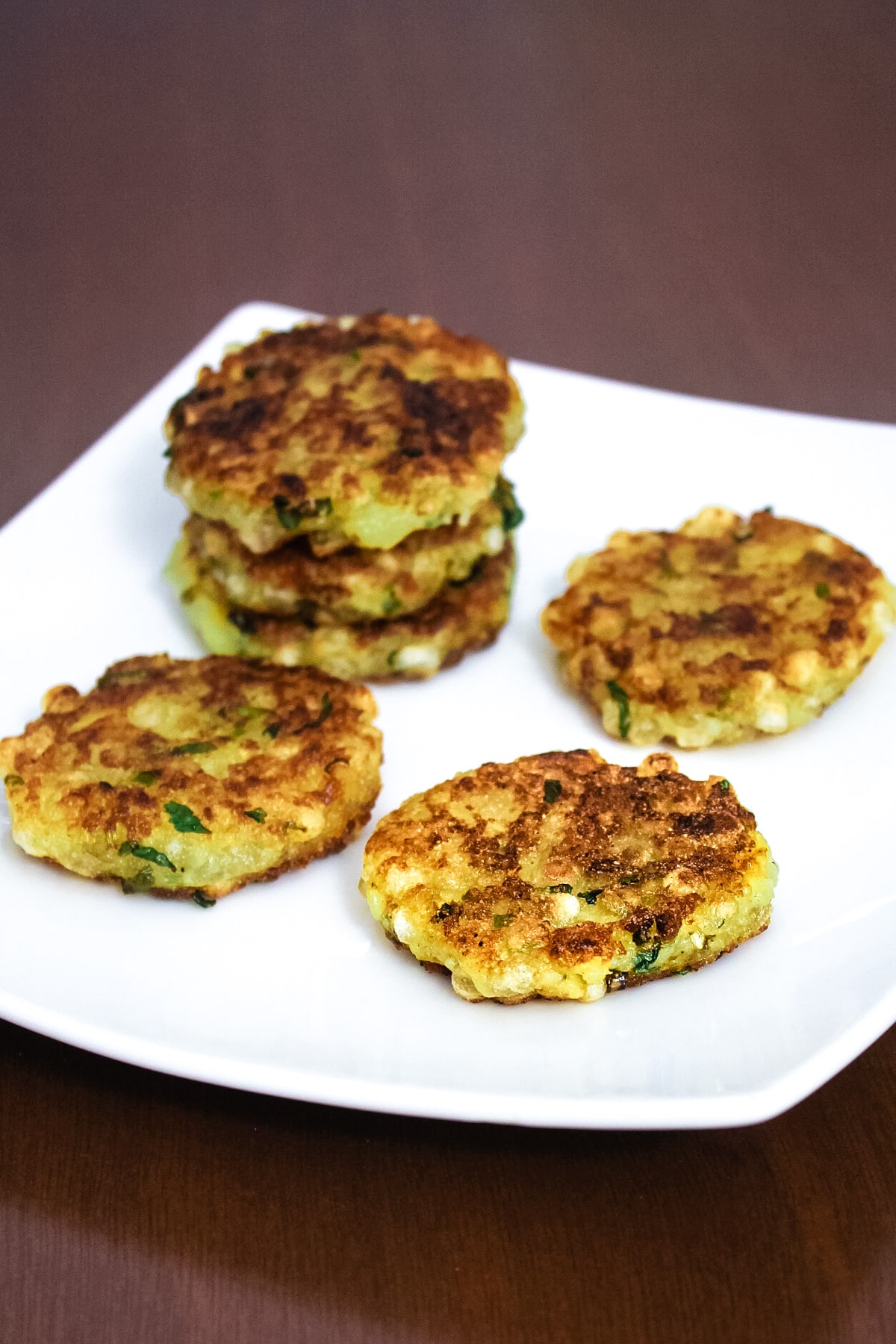 a stack of sabudana tikki with 3 tikkis in single layer in a plate