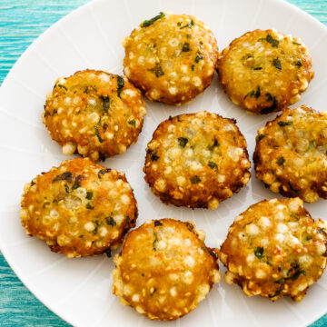 8 sabudana vada arranged in a white round plate