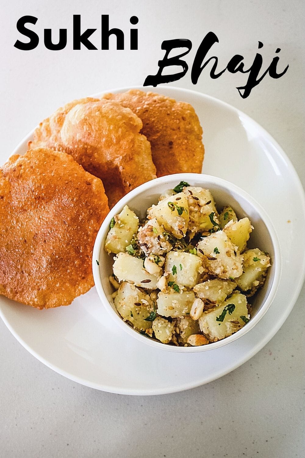 sukhi bhaji in a bowl served with puri in a plate with text on top of the image for pinterest