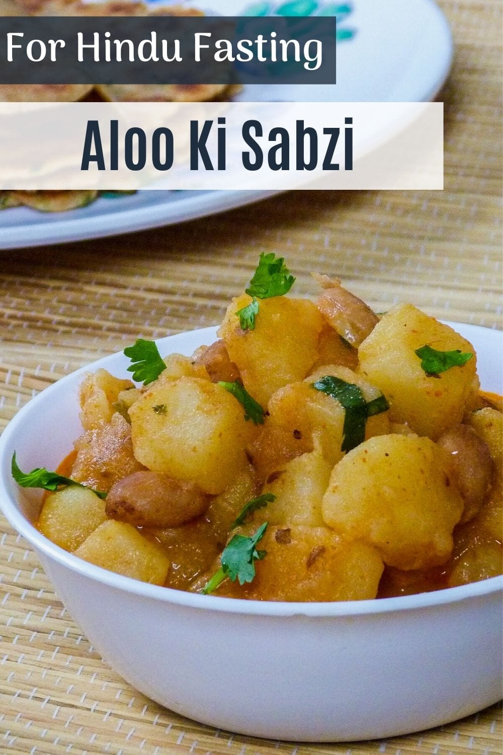 vrat wale aloo ki sabzi in a bowl with garnish of cilantro and text on top of the image for pinterest