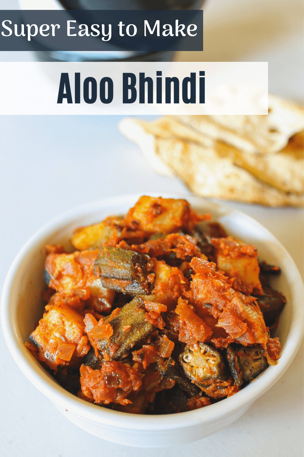 Aloo bhindi served in a bowl with text on the image for pinterest.