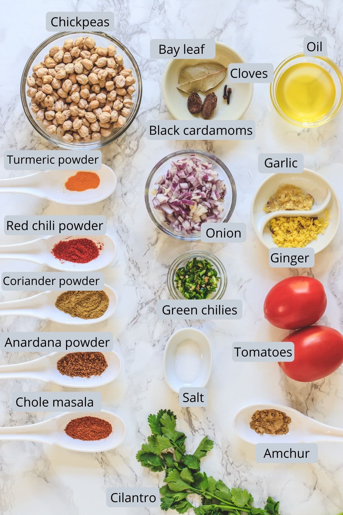 ingredients used in chana masala includes chickpeas, oil, onion, tomato, ginger, garlic, green chili, spices, salt and cilantro.