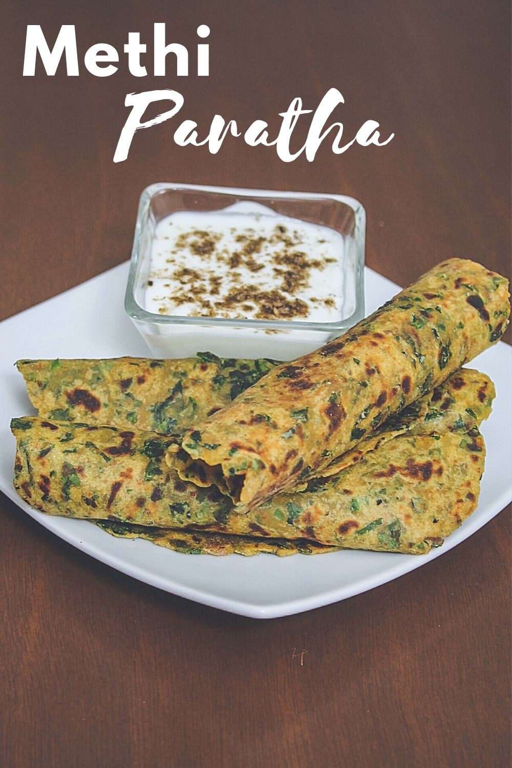 Methi paratha served with yogurt and text on the image for pinterest