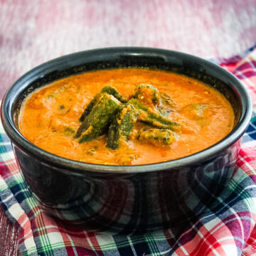 Bhindi curry in a bowl with napkin underneath the bowl.