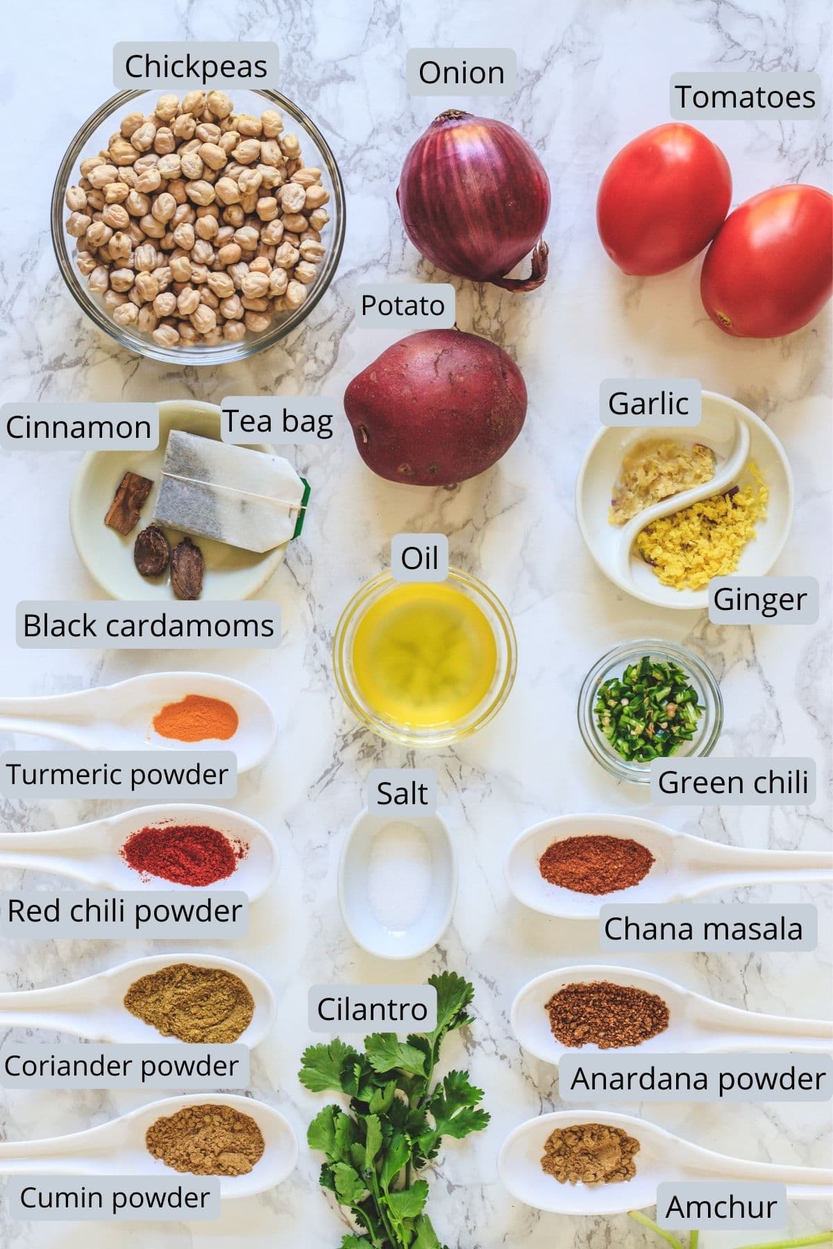 Ingredients used in aloo chana includes chickpeas, potato, onion, tomato, ginger, garlic, chili, cilantro, oil and spices.