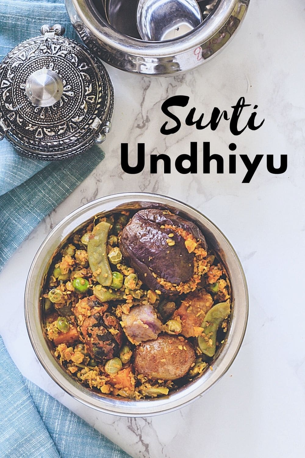 Undhiyu served in a steel bowl with text on the image for pinterest.