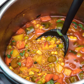 quinoa vegetable soup in instant pot ready to take a ladleful for serving.