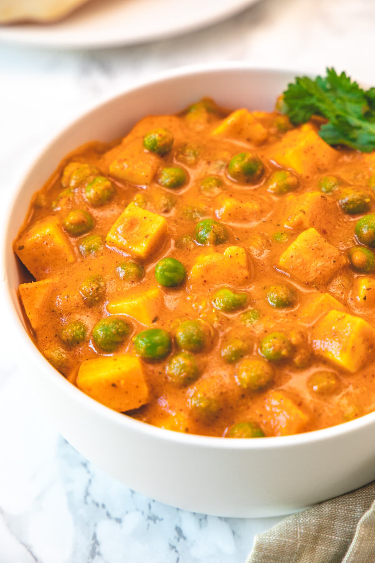 Matar paneer served in a bowl.