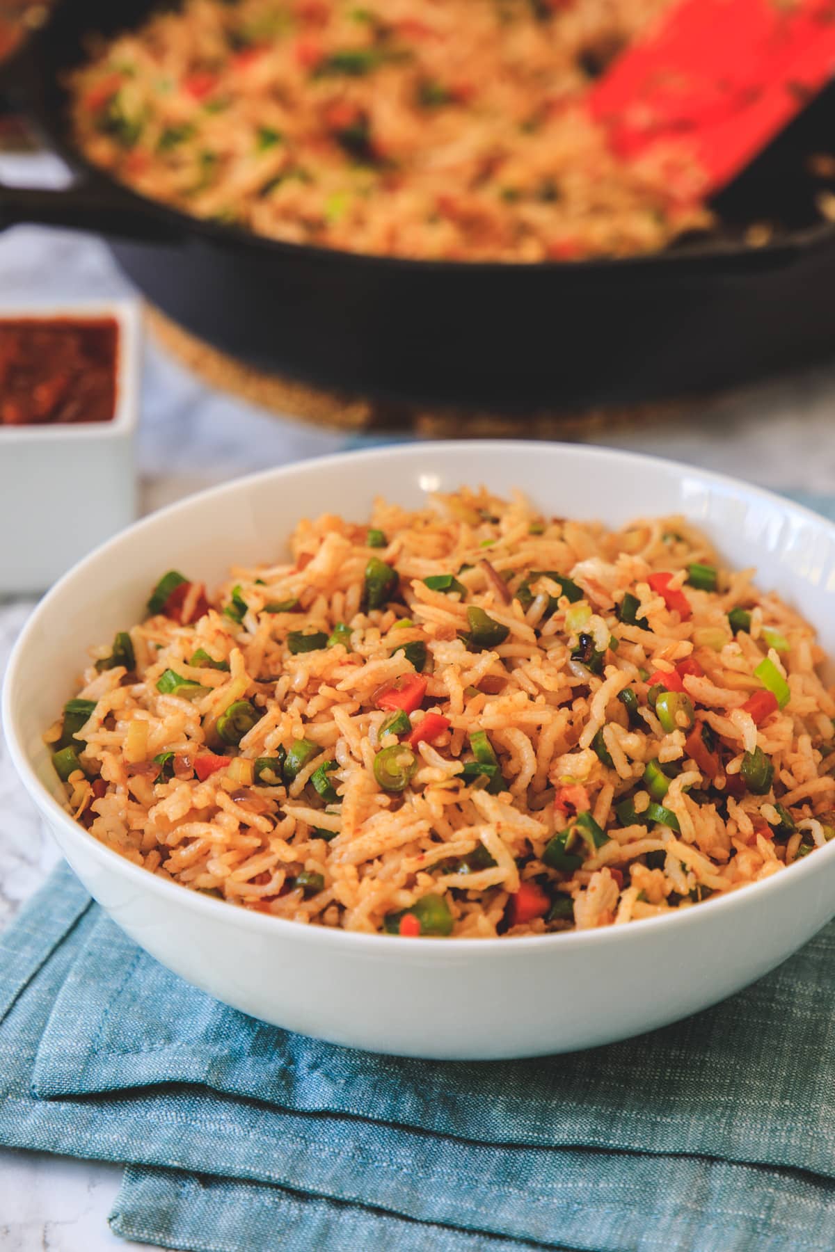 schezwan fried rice in a bowl with napkin underneath