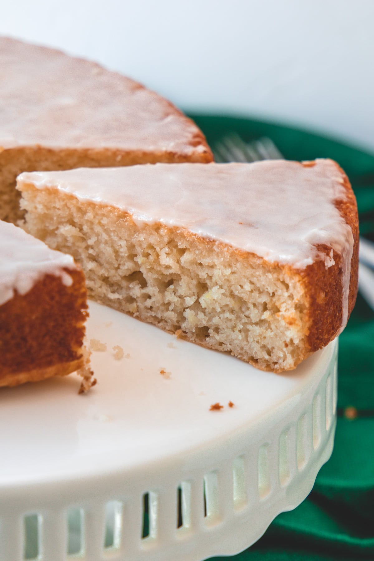 Close up of a slice of eggless lemon cake showing the inside texture.