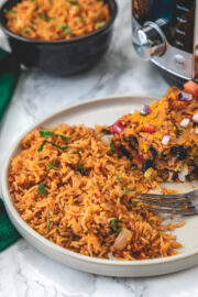 Instant pot mexican rice served in a plate with enchilada casserole.