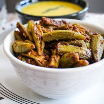 Bhindi masala served in white bowl.