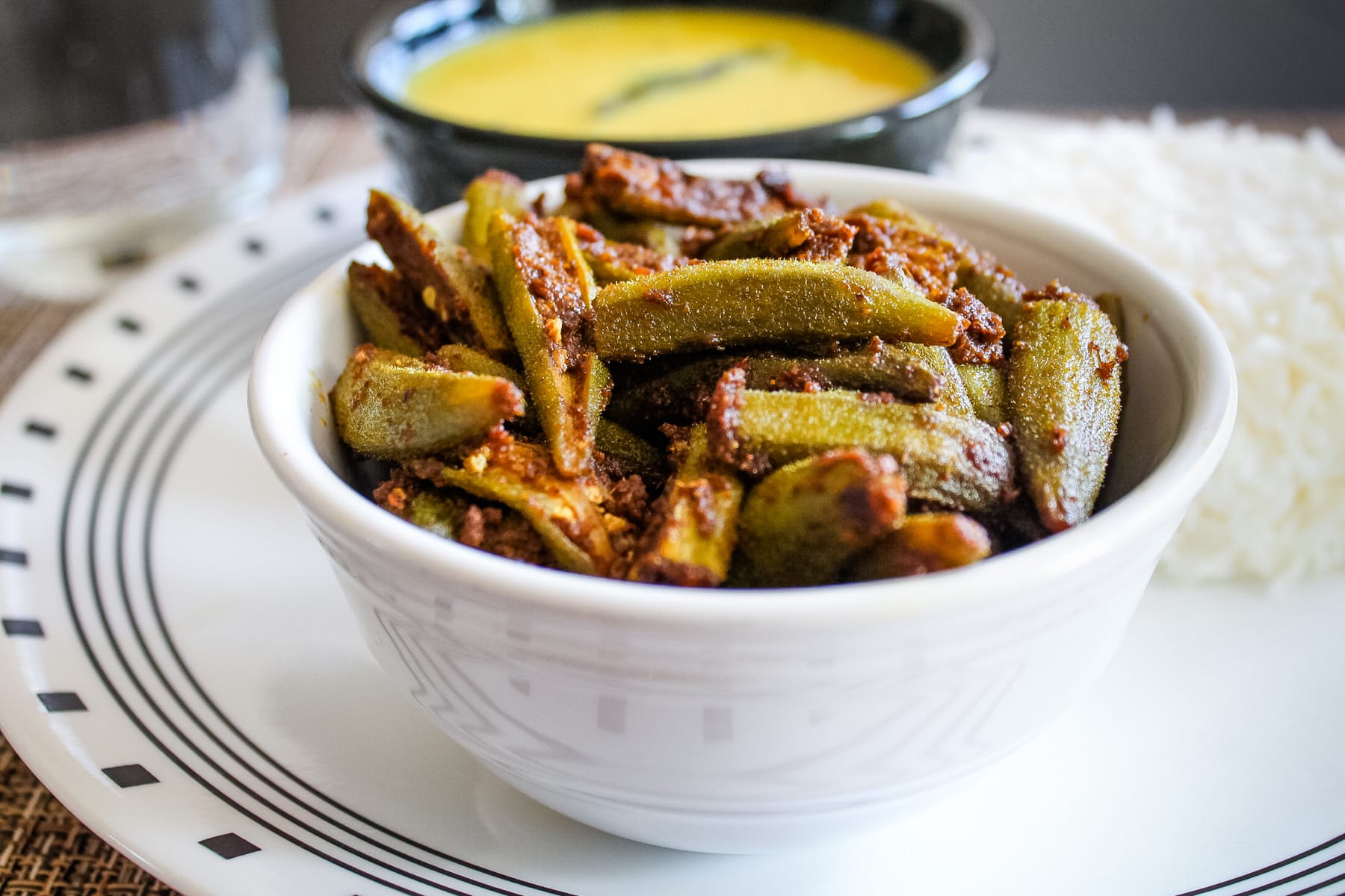 Bhindi masala served in white bowl.