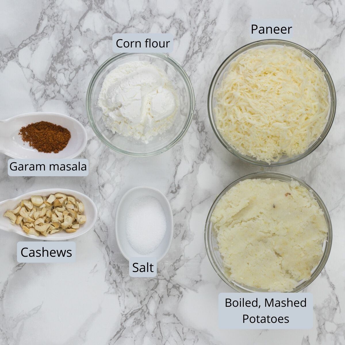 Kofta ingredients in individual bowls and spoons.