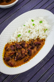 Rajma chawal served in oval plate, garnished with cilantro.