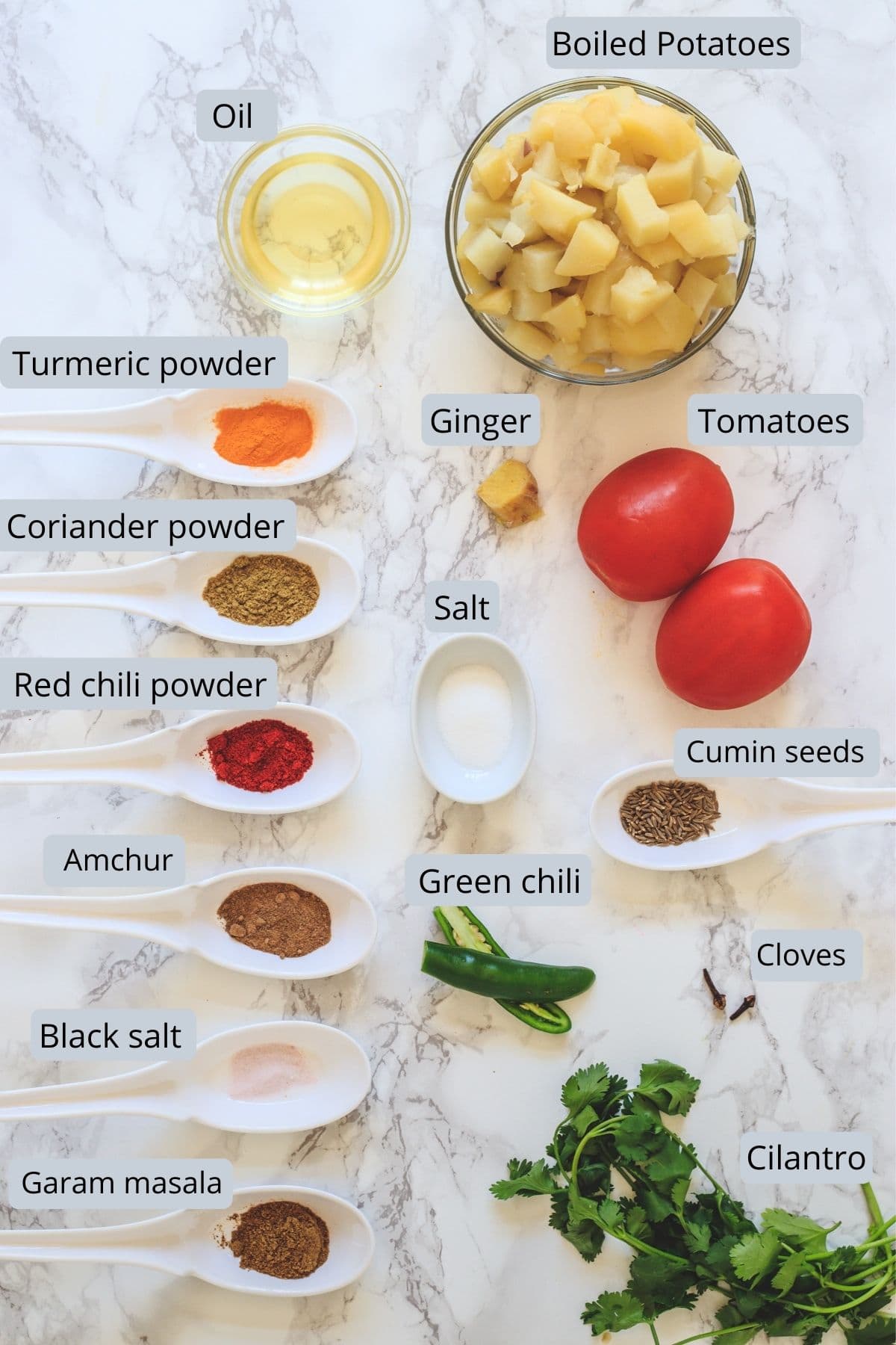Ingredients for aloo puri in individual spoons and bowls.