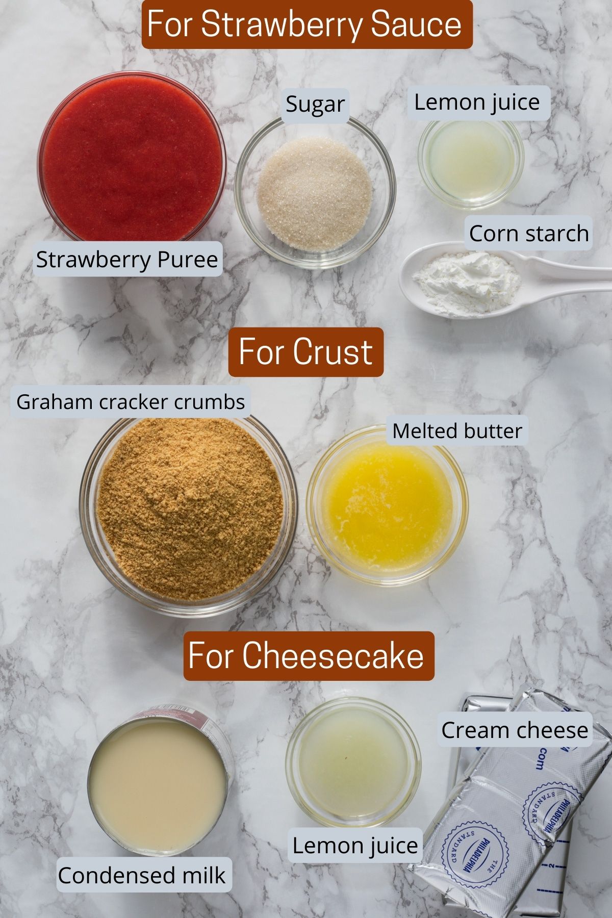 Ingredients for strawberry cheesecake removed into individual bowls.