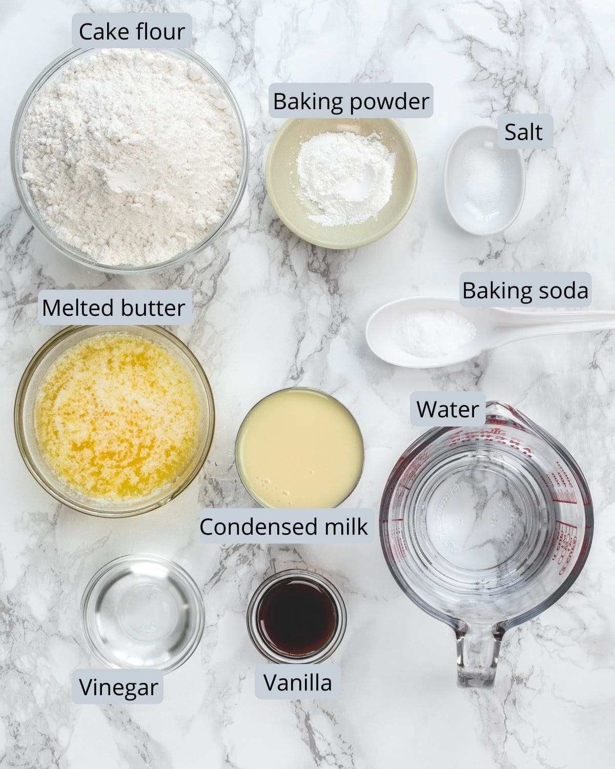 Ingredients use for eggless vanilla cake recipe in individual bowls.