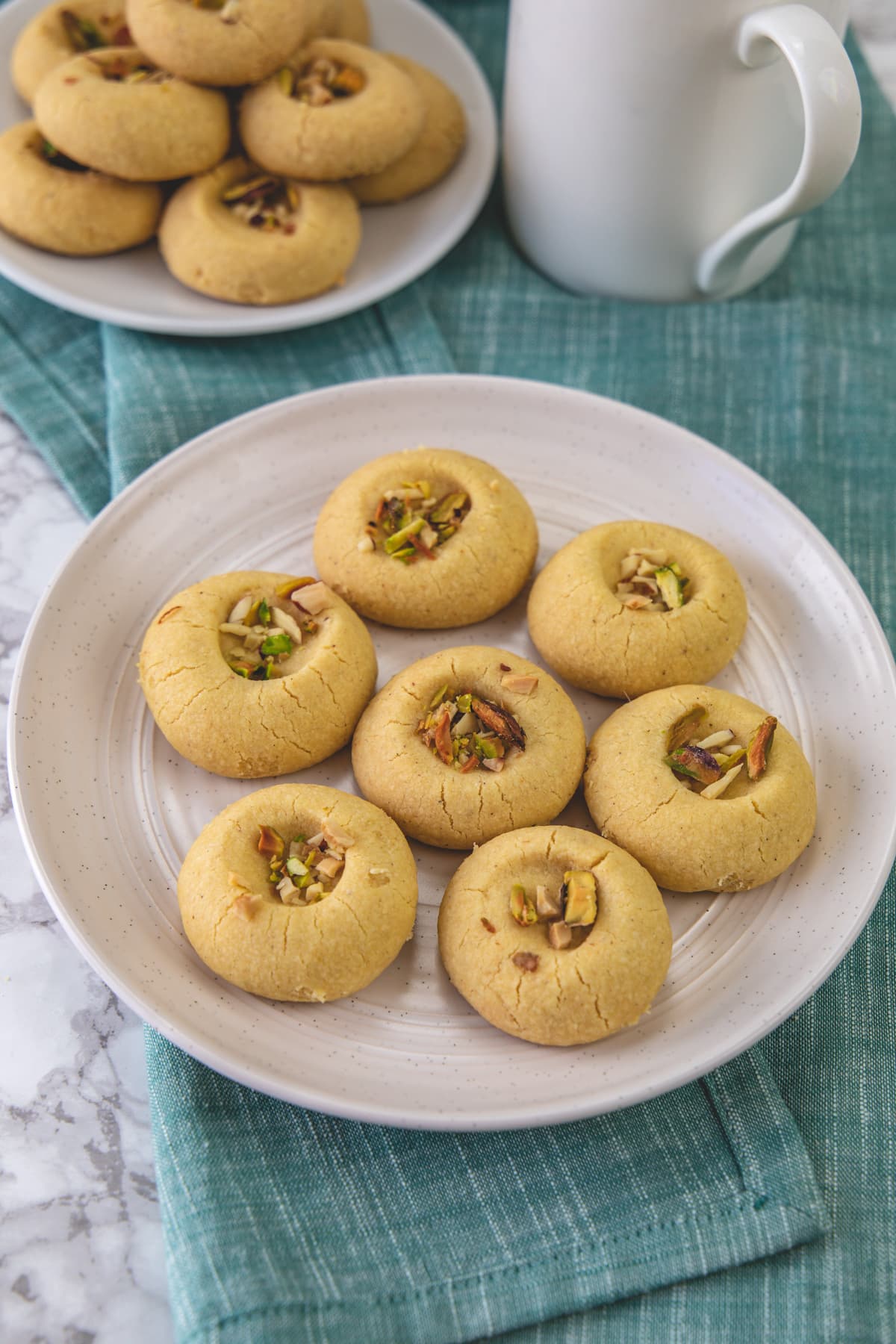 Nankhatai arranged in a plate with napkin underneath.