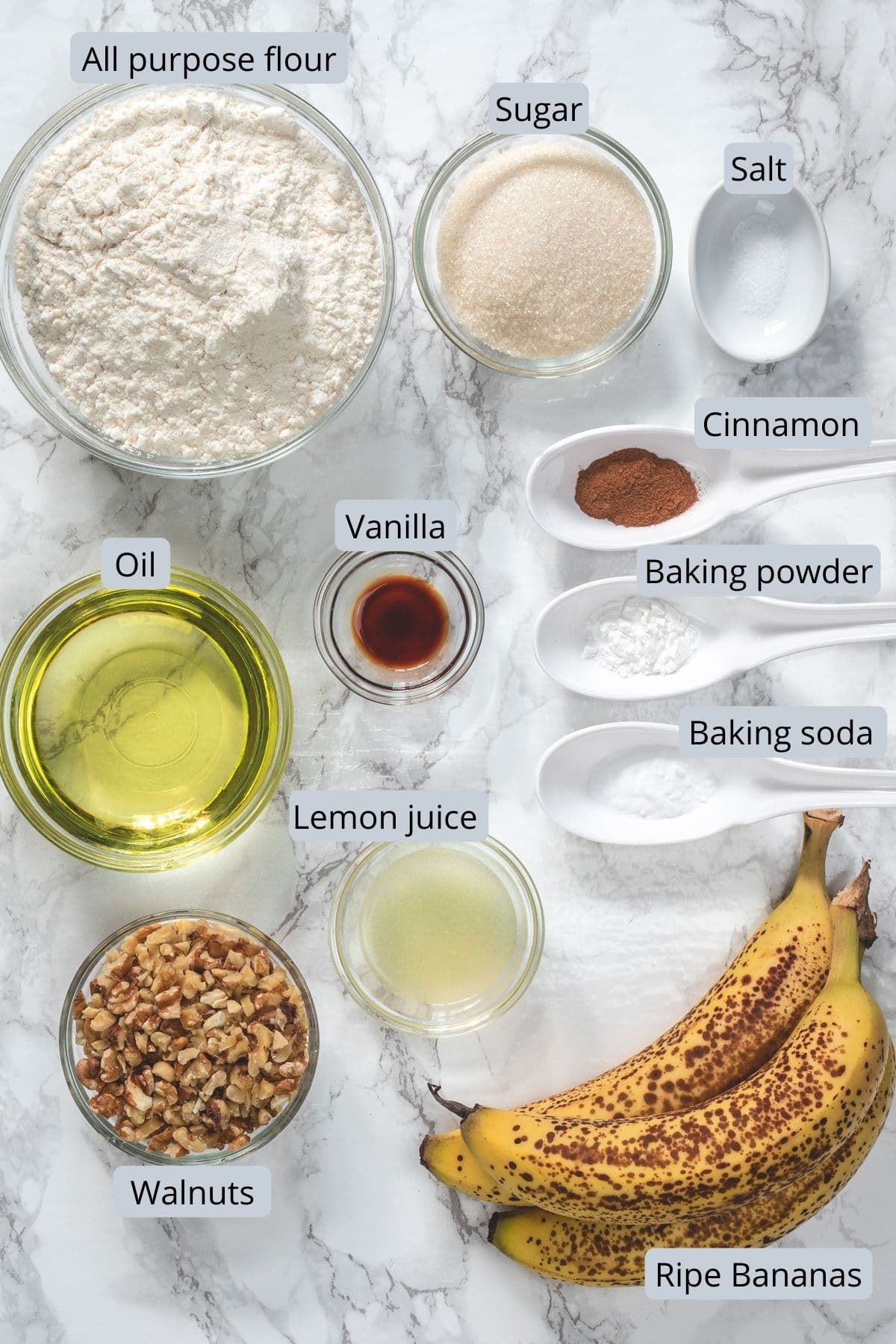 Eggless banana bread ingredients removed in individual bowls and spoons.