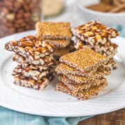 4 stacks of til chikki and peanut chikki in a plate